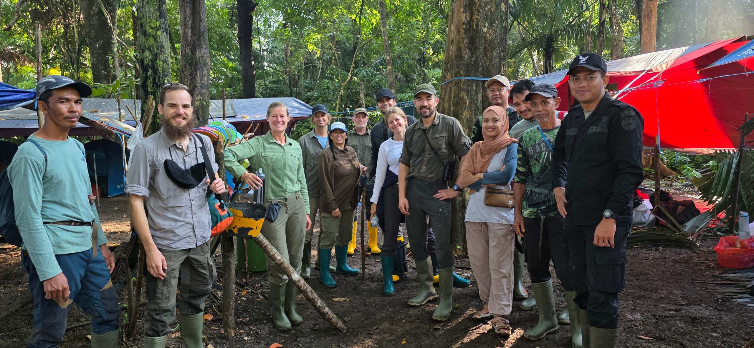 Edge group team stood smiling at the camera, in the national park